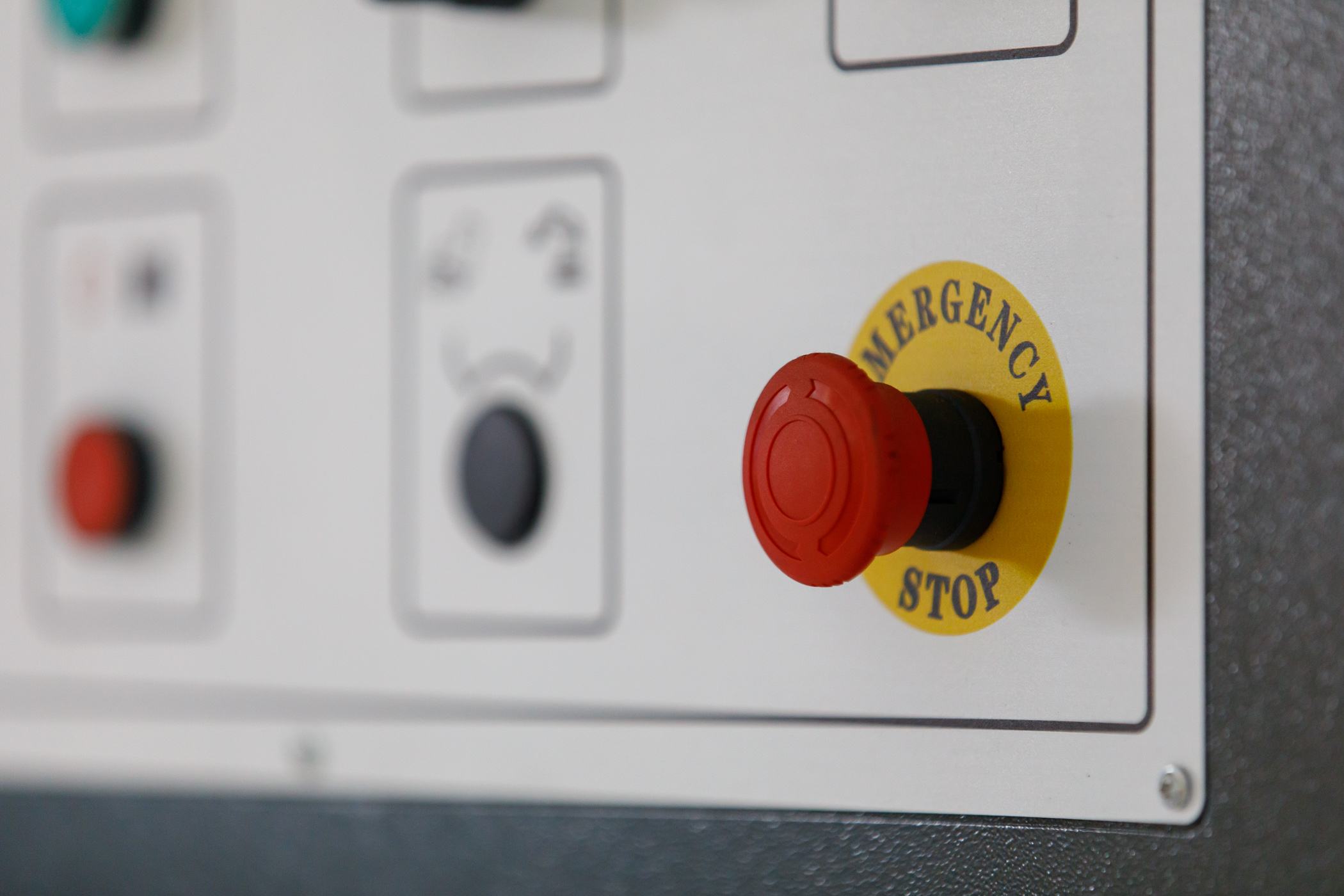 Emergency stop button on a machine control panel