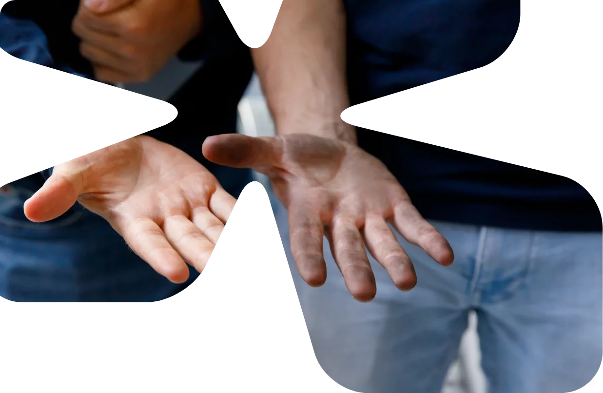 Hands of two mechanics, cut out in the shape of the Summix logo